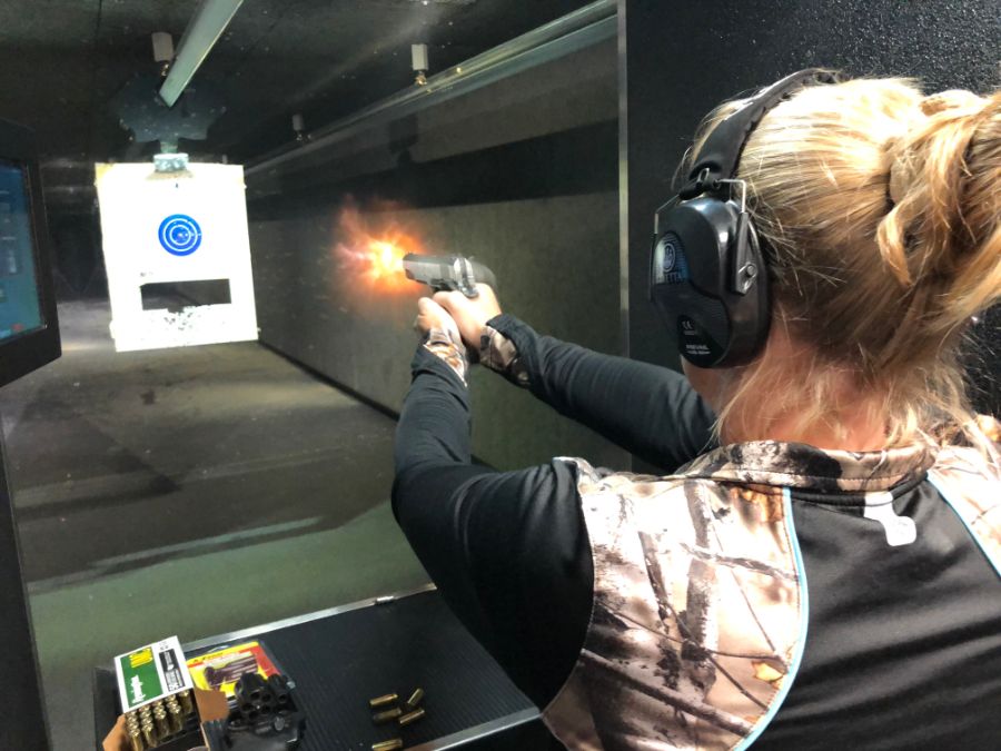 Woman shooting at target at Timberline Firearms shooting Range