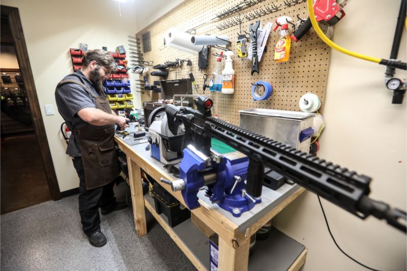 Timberline Firearms employee cleaning a gun.