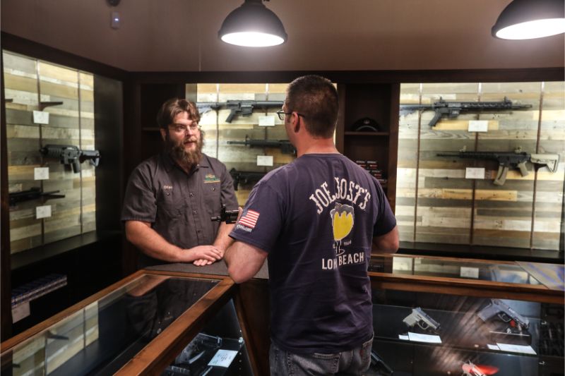 Timberline Firearms employee helping out visitor at the gun retail counter.