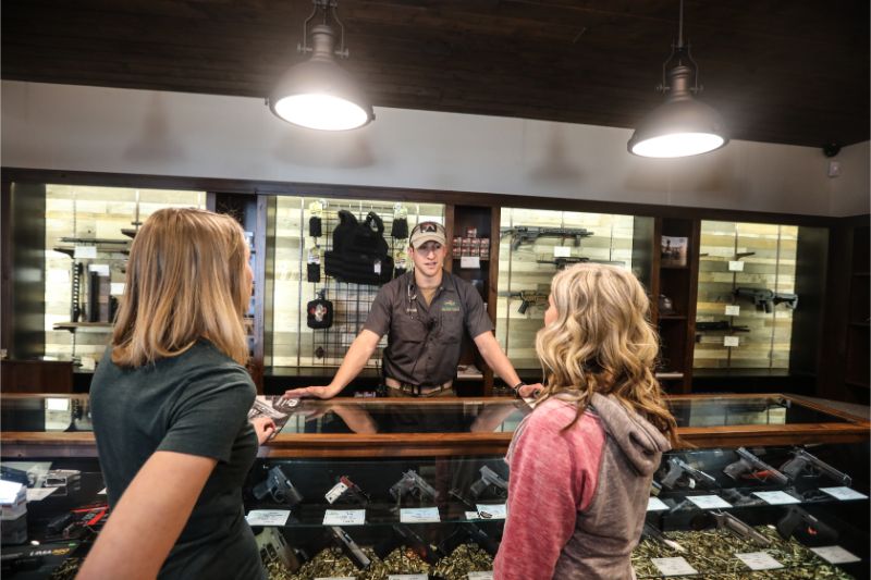 Timberline Firearms worker selling guns to visitors.